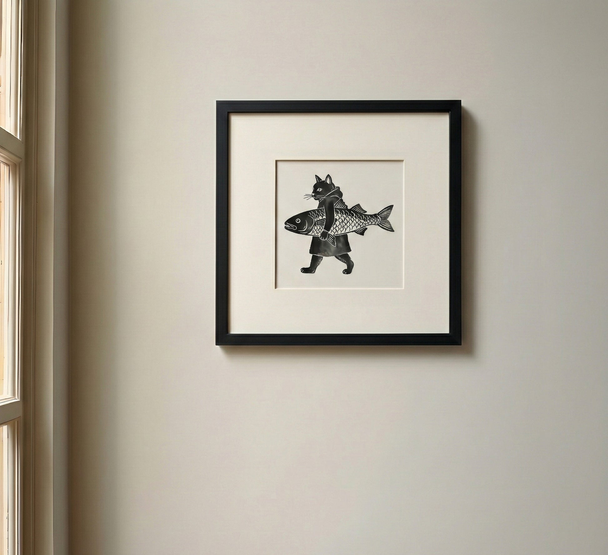 Framed Japanese black and white artwork of a cat holding a fish.