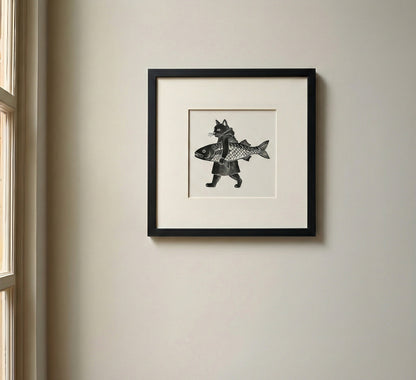 Framed Japanese black and white artwork of a cat holding a fish.